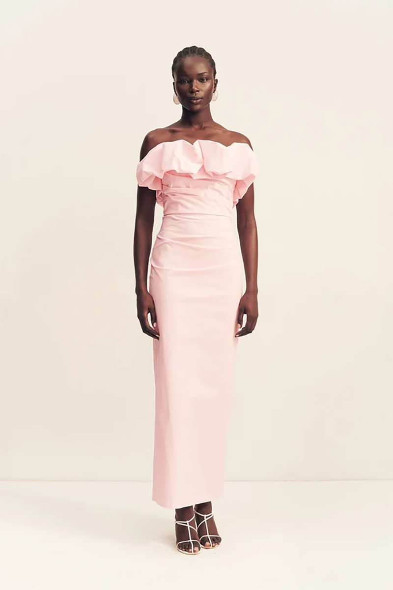 A model wearing a ballerina pink Campbell Strapless Bubble Maxi Dress with a ruffled neckline and ruched waist detail.