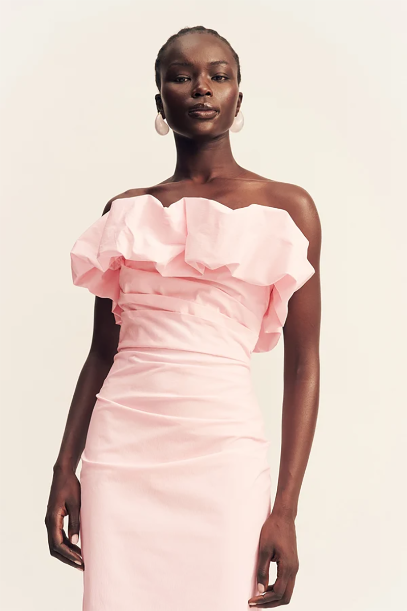 A model wearing the ballerina pink, strapless bubble maxi dress by Shona Joy, featuring a ruffled bodice.