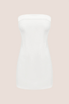 The Chloe Corset Dress by With Jean is showcased on a plain beige background, featuring a white strapless mini design with a fitted, simple silhouette and a straight neckline—an elegant option for formal evening occasions.