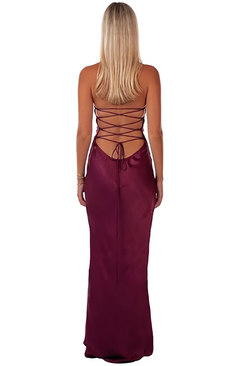 Back view of the Jade Maxi Dress in Berry, featuring a burgundy satin fabric and a lace-up open back.